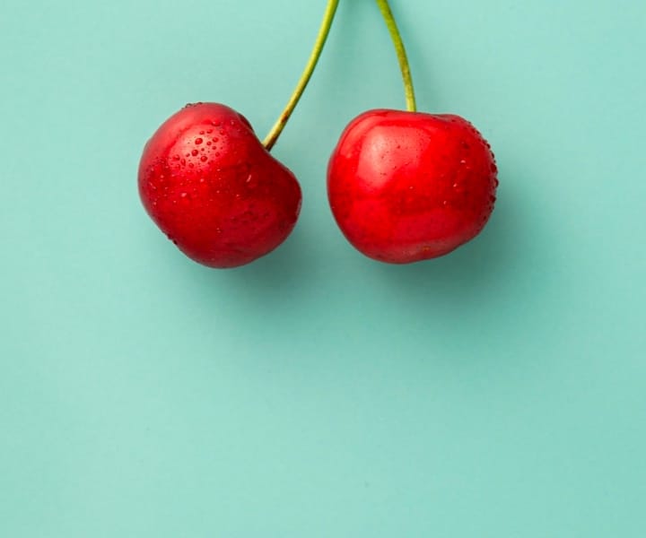 Red cherries on mint green background
